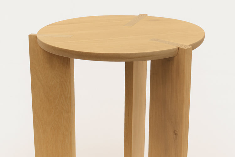 Wooden stool with a round seat on a white background